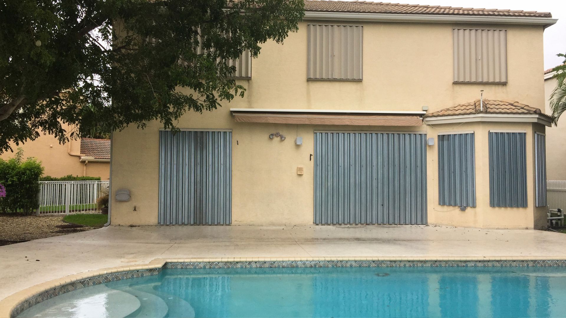 A house with a pool in front of it