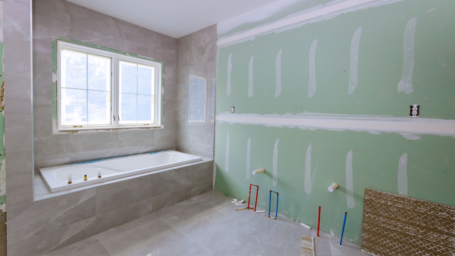 A bathroom with a tub and a window in it